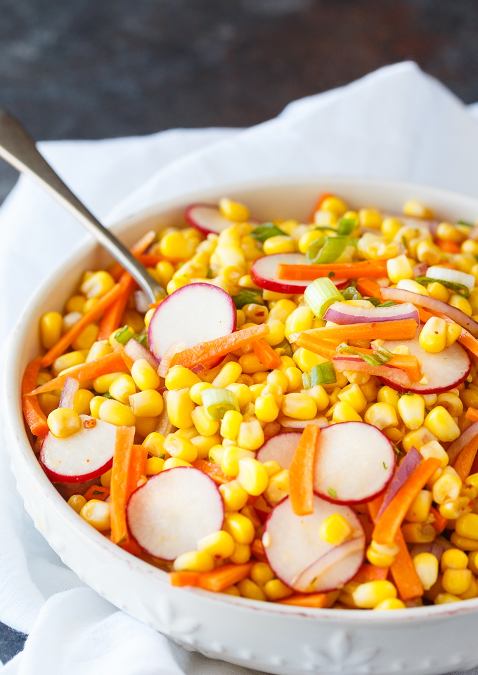 Corn Salad - Eat the rainbow with this recipe! Add some extra crunch to this simple summer side dish with carrots, radishes, red onions, and a simple salad dressing.