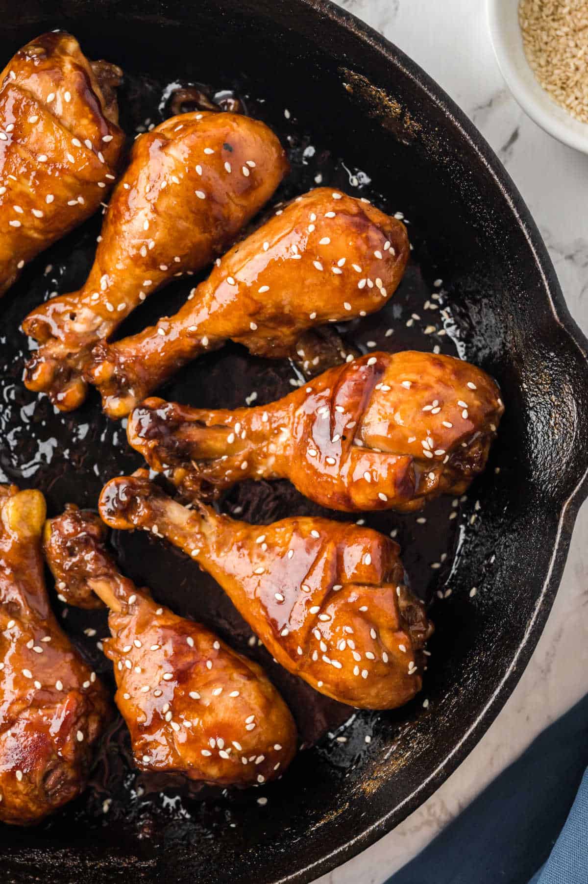 Sticky chicken in a cast iron skillet.