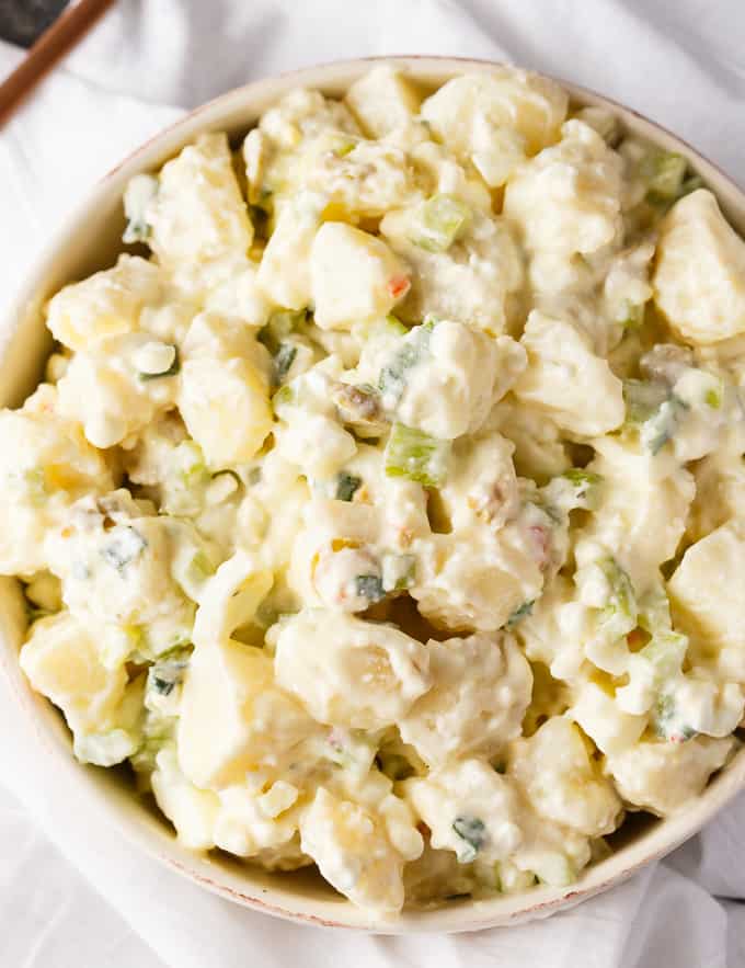 Cheese Potato Salad - Who doesn't love cheese?! Add some to this BBQ side dish with hard boiled eggs, green olives, celery, and green onions.