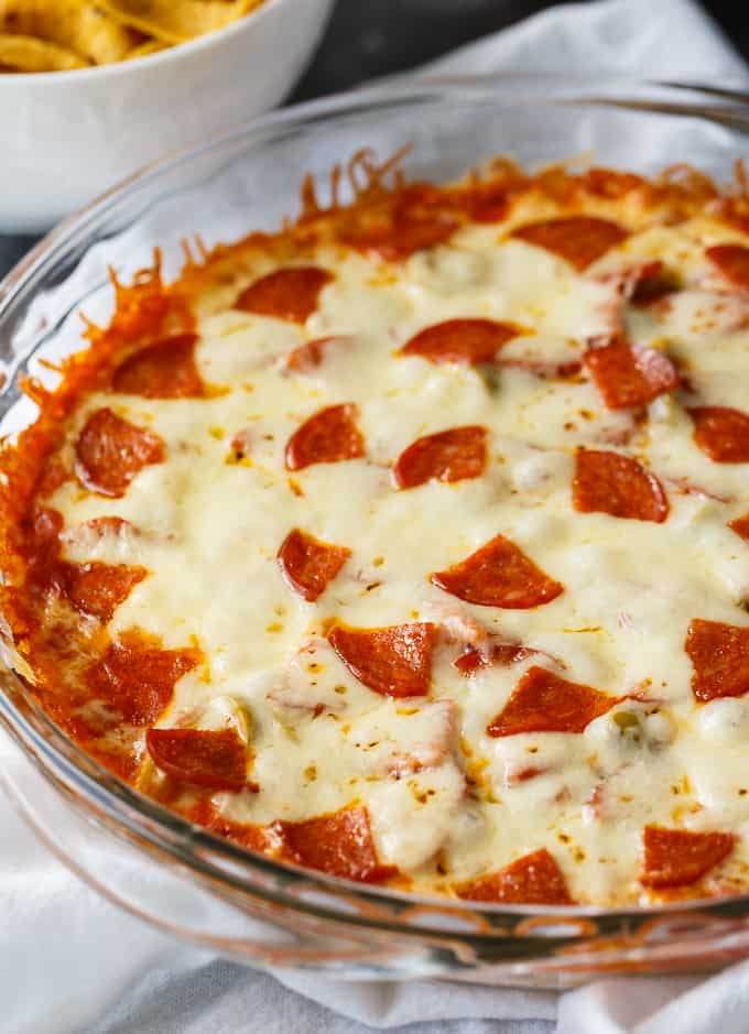 Pizza Dip - If you love pizza, you are going to LOVE this hot dip appetizer. Layers of cream cheese, pizza sauce, melty mozzarella cheese and your favorite pizza toppings make this dip a surefire hit.