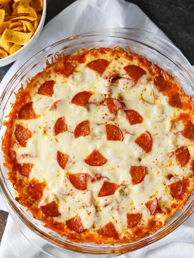 Pizza Dip - If you love pizza, you are going to LOVE this hot dip appetizer. Layers of cream cheese, pizza sauce, melty mozzarella cheese and your favorite pizza toppings make this dip a surefire hit.