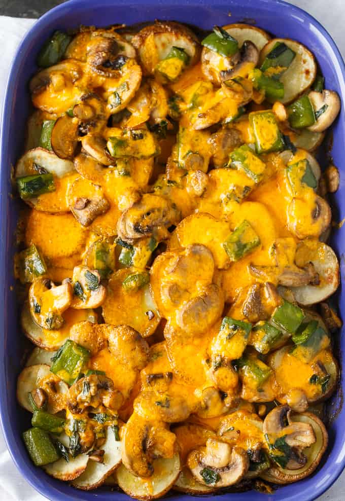 Smothered Potatoes - Thinly sliced potatoes are baked to perfection in a blanket of mushrooms, green onions, green peppers and cheddar cheese. Serve as a side dish or appetizer.