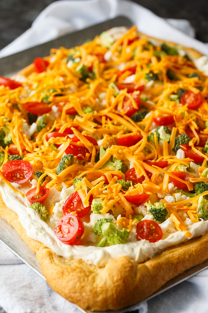 Vegetable Pizza - This easy appetizer is perfect for parties and potlucks. It's made with crescent roll dough, ranch dressing mix and loads of fresh, crispy veggies. Yum!