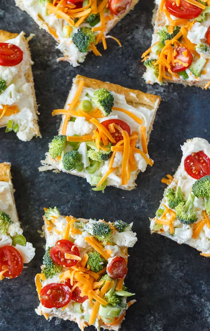 Vegetable Pizza - This easy appetizer is perfect for parties and potlucks. It's made with crescent roll dough, ranch dressing mix and loads of fresh, crispy veggies. Yum!