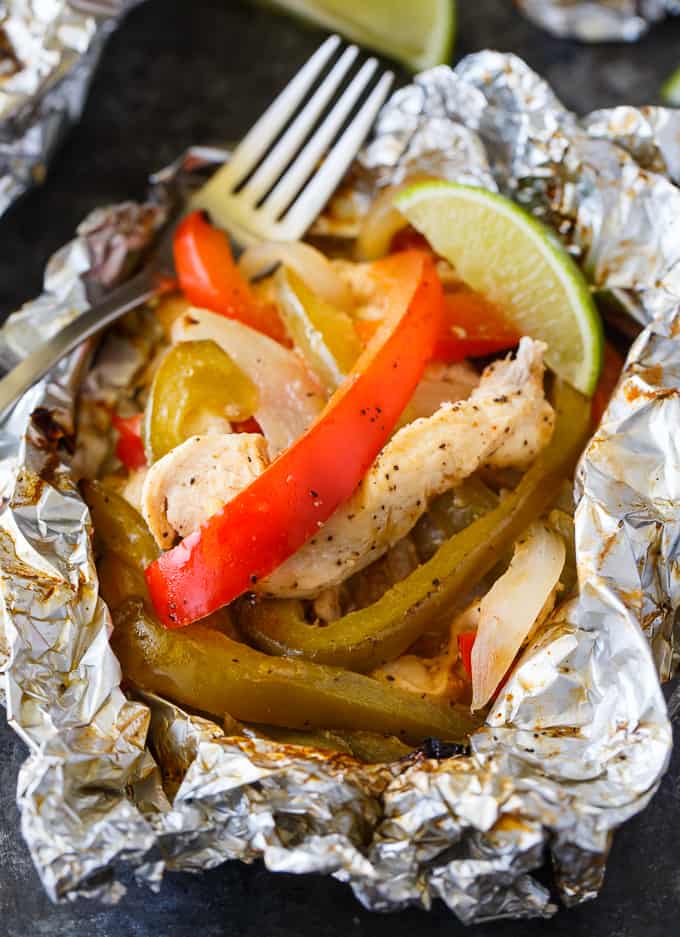 Chicken Fajita Foil Packets - Flavor packed and low carb! This easy grilling recipe is made with tender chicken, peppers and onions seasoned with the yummy tastes of fajitas.