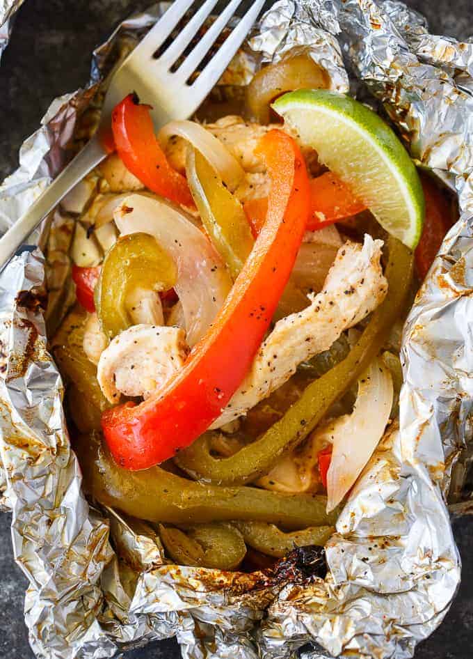 Chicken Fajita Foil Packets - Flavor packed and low carb! This easy grilling recipe is made with tender chicken, peppers and onions seasoned with the yummy tastes of fajitas.