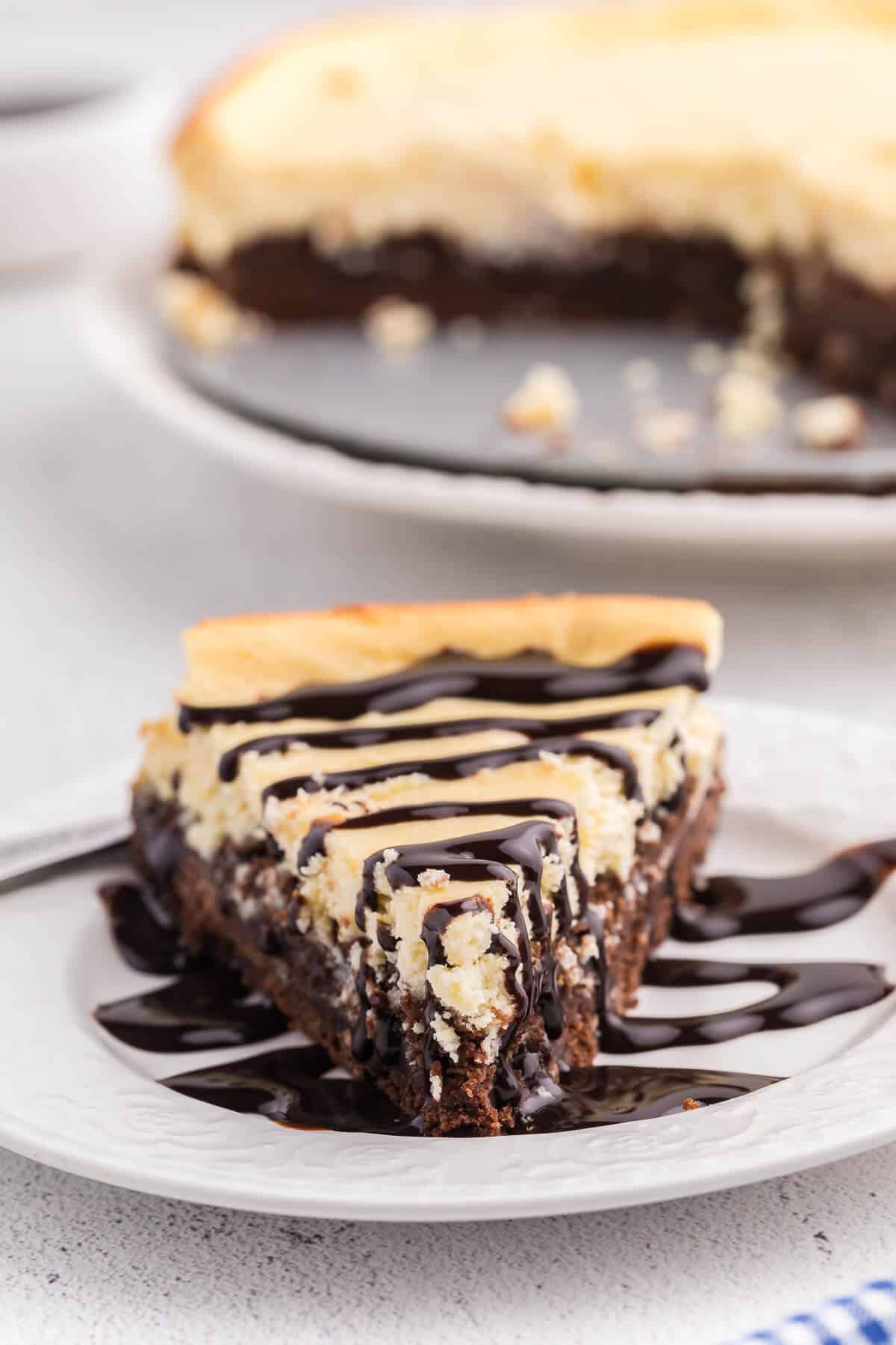 a slice of brownie bottom cheesecake on a plate