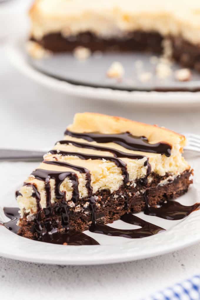 a slice of brownie bottom cheesecake on a plate