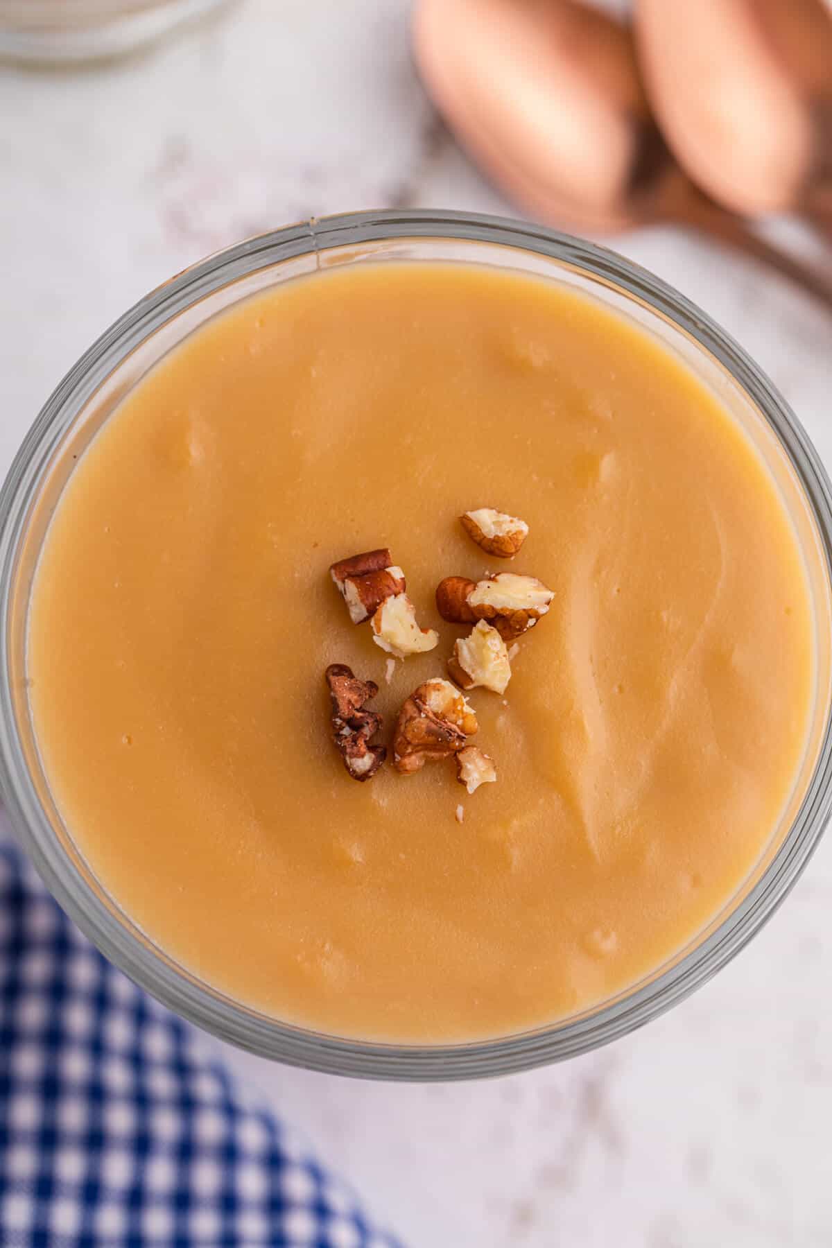 Butterscotch pudding topped with pecans.