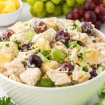 A bowl of chicken salad with grapes.