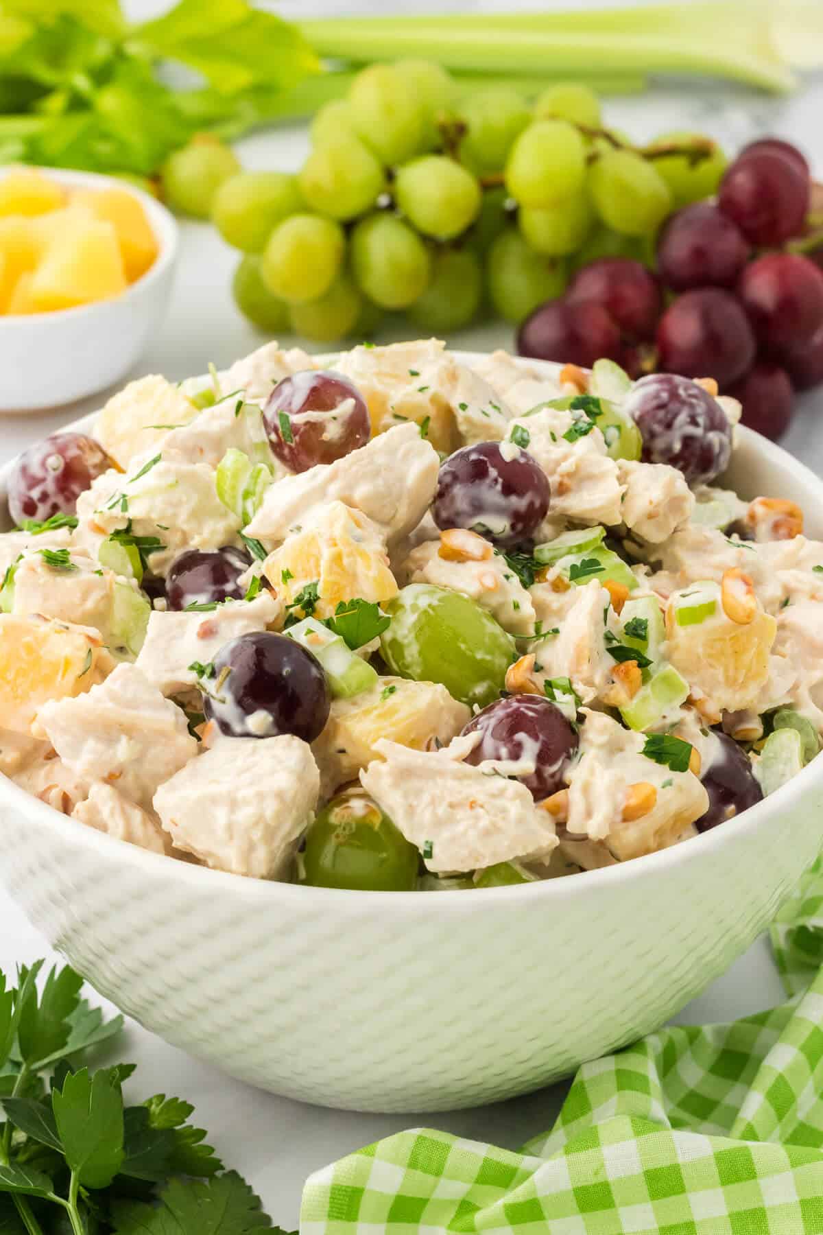 A bowl of chicken salad with grapes.