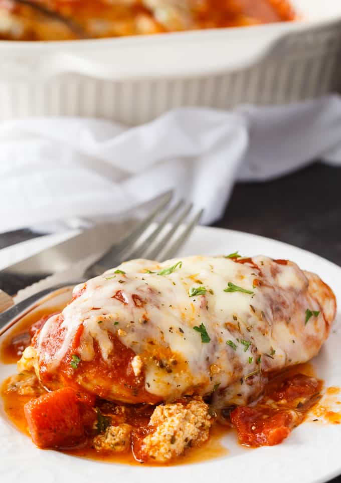 Lasagna Stuffed Chicken - Keto comfort food! Tender chicken breasts are stuffed with a ricotta filling and smothered in marinara sauce and mozzarella cheese.