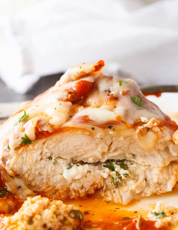 Lasagna Stuffed Chicken - Keto comfort food! Tender chicken breasts are stuffed with a ricotta filling and smothered in marinara sauce and mozzarella cheese.