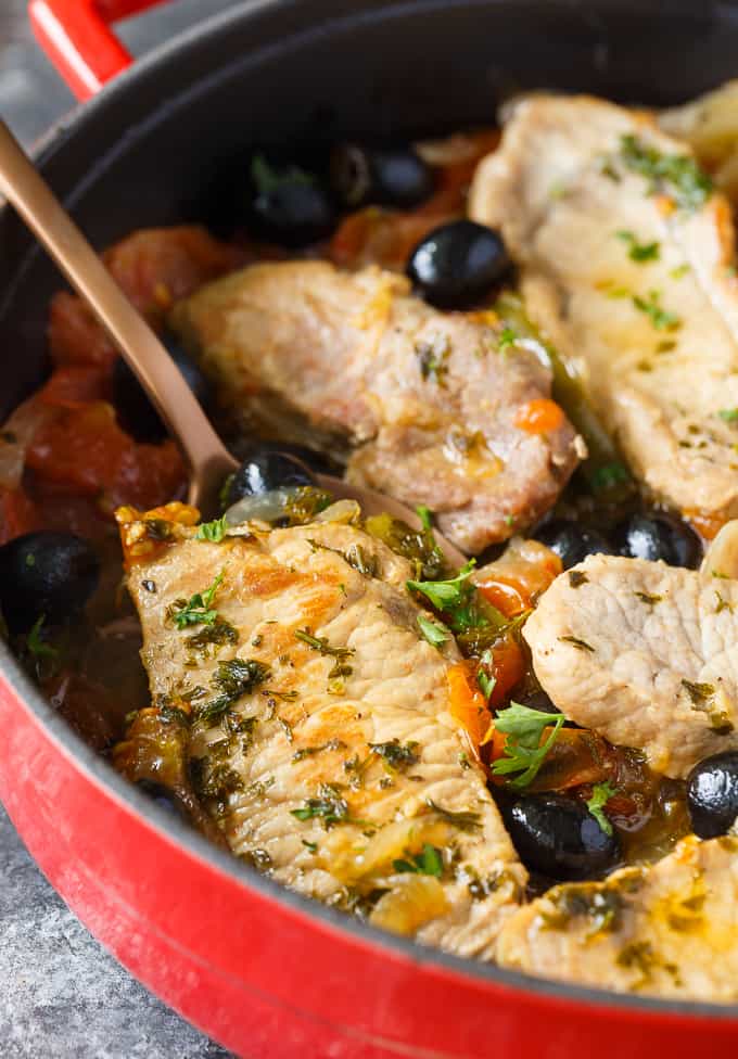 Savory Pork Chops - Tender pork chops are cooked in a savory sauce filled with tomatoes, garlic, green peppers, black olives and spices. A super easy weeknight meal for your family. 