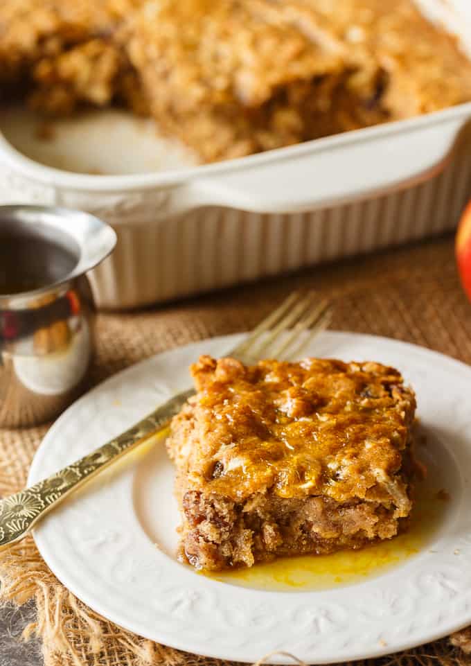 Apple Spice Cake - A sweet fall cake made with apples, raisins and spices and topped with a delicious orange glaze. #apples #spicecake