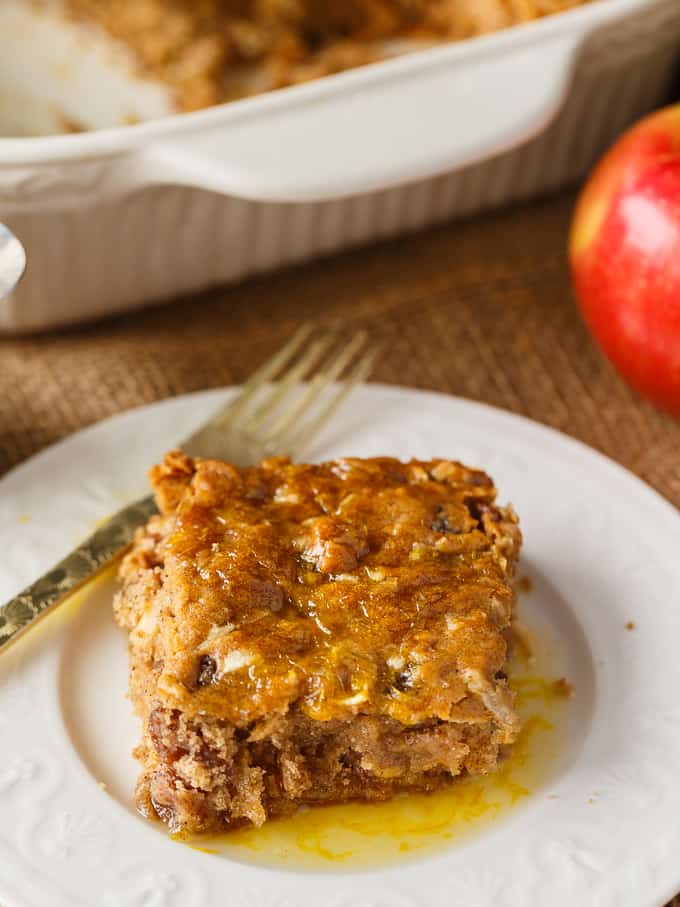 Apple Spice Cake - A sweet fall cake made with apples, raisins and spices and topped with a delicious orange glaze. #apples #spicecake