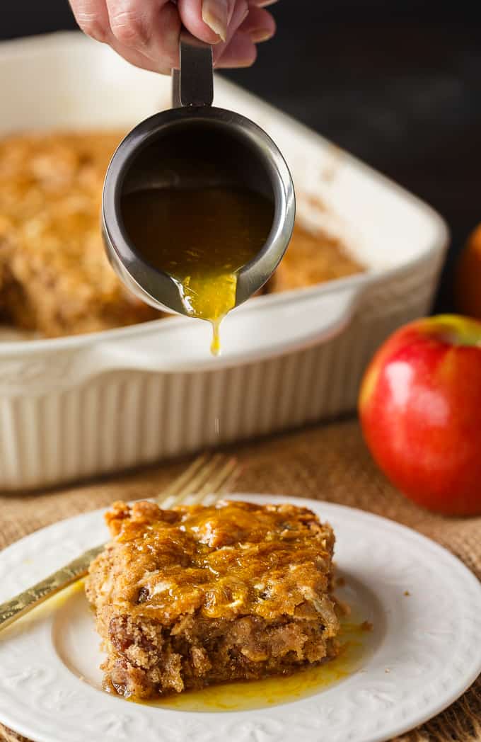 Apple Spice Cake - A sweet fall cake made with apples, raisins and spices and topped with a delicious orange glaze. #apples #spicecake