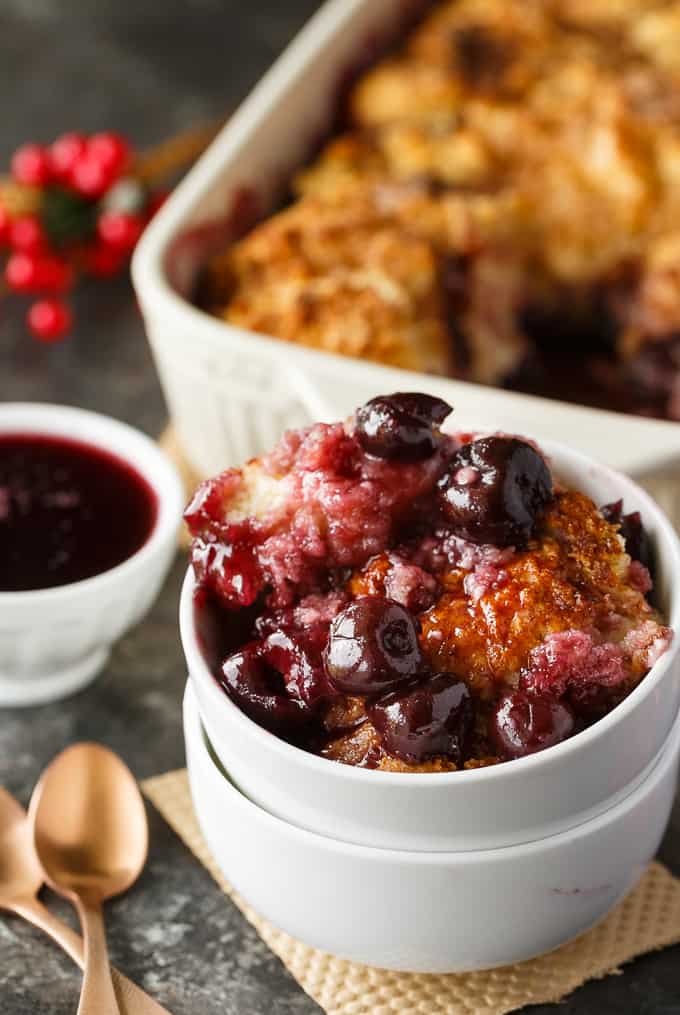 Winter Cherry Cobbler - Super easy and tastes like a dream! Tart cherries are baked in their sweet juices and topped with cake. It's bubbly and delicious.