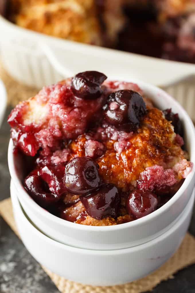 Winter Cherry Cobbler - Super easy and tastes like a dream! Tart cherries are baked in their sweet juices and topped with cake. It's bubbly and delicious.