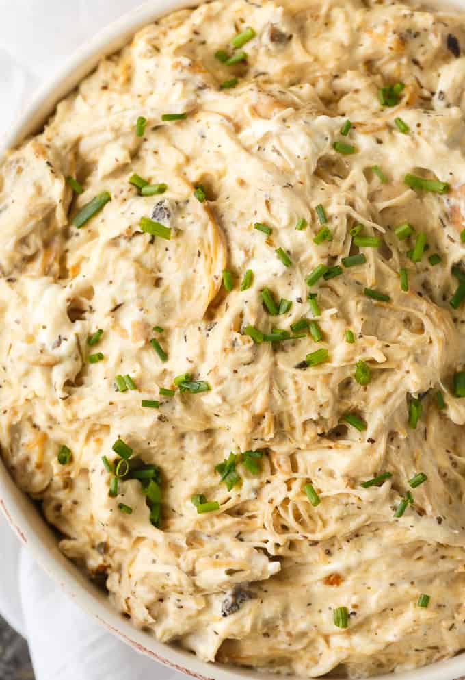 Slow Cooker Cream Cheese Chicken - Hearty and comforting! This shredded chicken in the Crockpot simmers all day in a luscious cream cheese sauce with Italian seasoning, garlic, celery seed, and cream of mushroom soup.