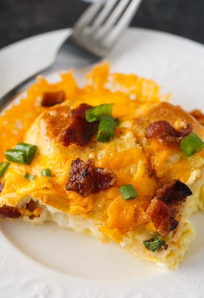 Bacon and Egg Biscuit Casserole - An easy breakfast casserole recipe made with eggs, bacon and biscuits. It's super easy to whip up and can be made the night before and kept in the fridge.