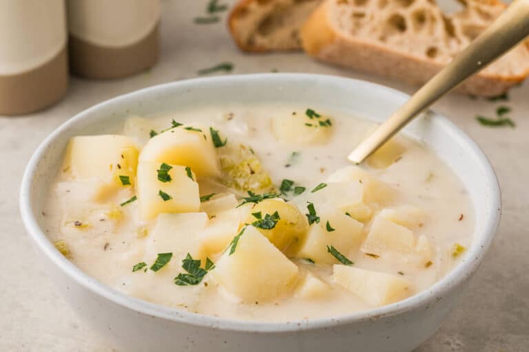 A bowl of soup with a spoon.