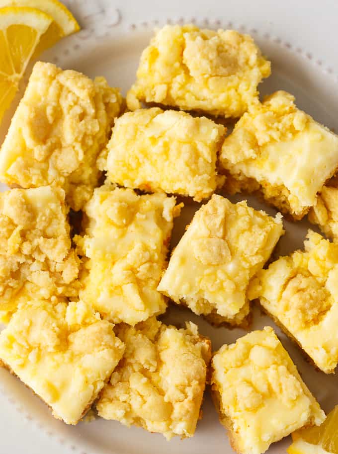 Lemon Cheese Bars - Slightly tart and sweet, this easy dessert is going to be a hit! Save time by using a box of cake mix topped with a lemony cheesecake topping.
