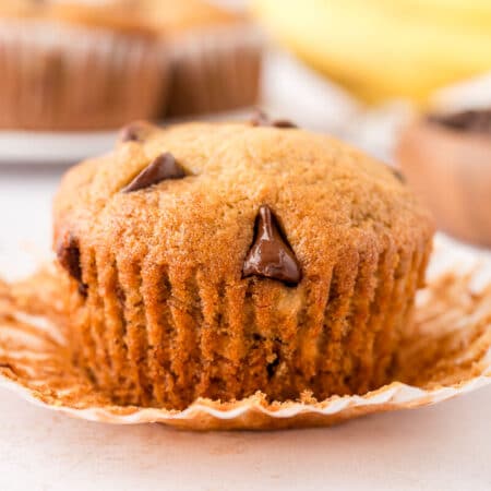 A banana chocolate chip muffin with the wrapper unwrapped.