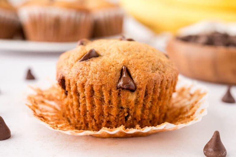 A banana chocolate chip muffin with the wrapper unwrapped.