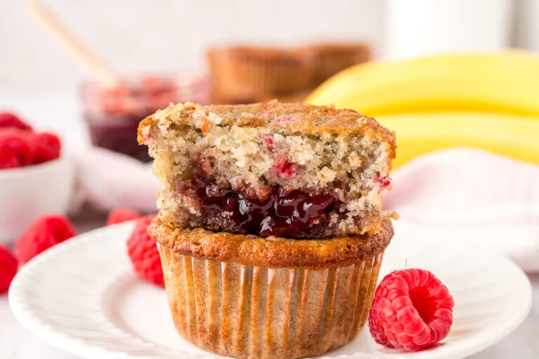 A stack of banana raspberry muffins on a plate.