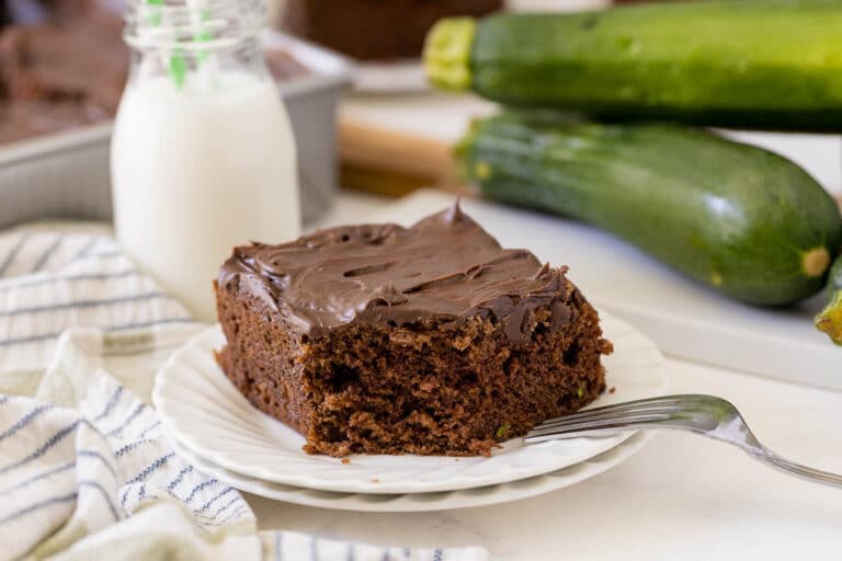 A piece of chocolate zucchini cake on a plate.