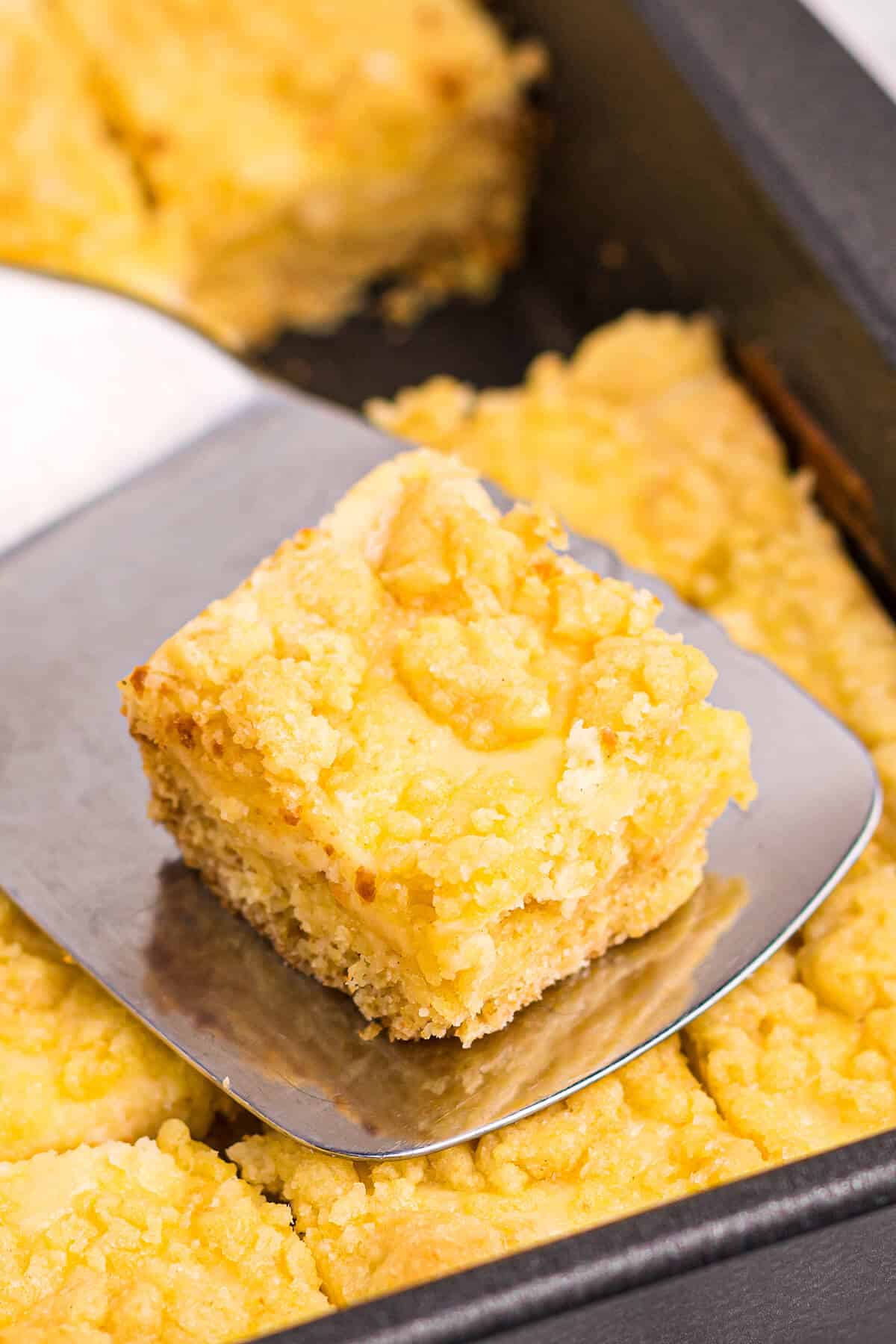 Lemon cheese bar on a spatula.