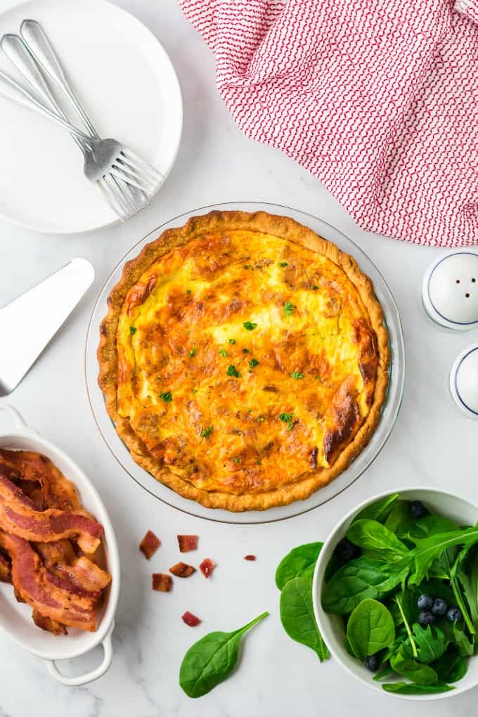 Quiche Lorraine - Easy and quick to prepare, this breakfast or brunch recipe will quickly become a weekly staple. It’s full of flavor that comes from just the right combination of bacon, cheese, half and half and eggs. Plus a little nutmeg and paprika to take it to the next level.