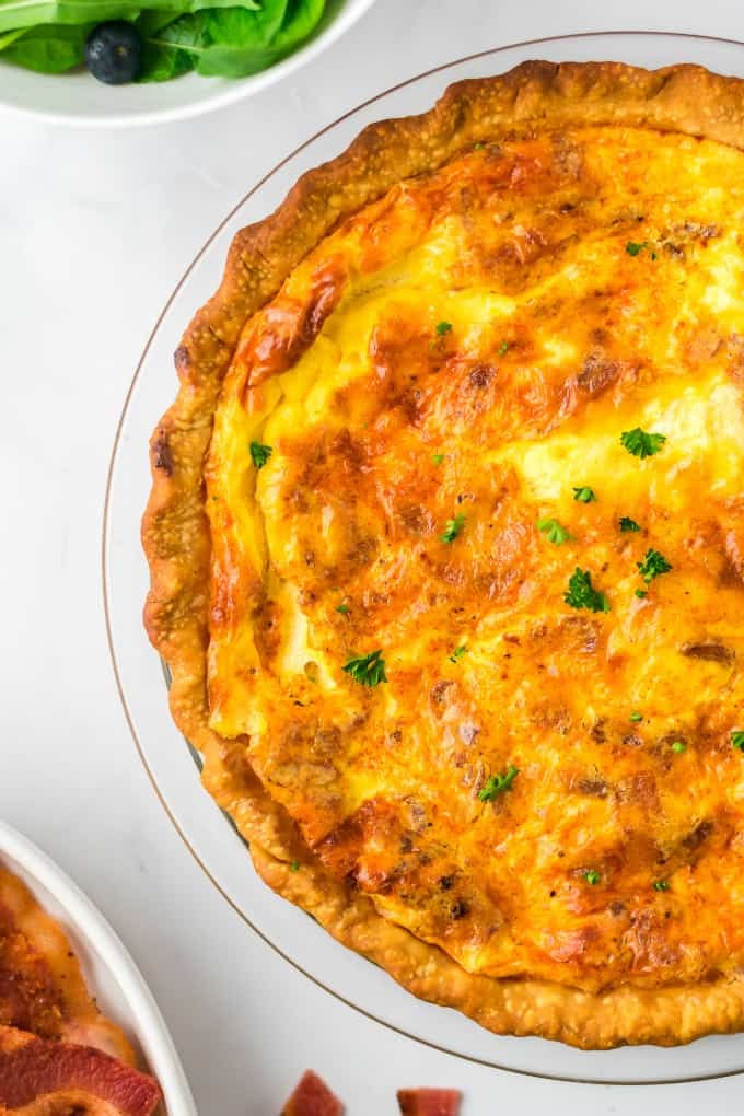 Quiche Lorraine - Easy and quick to prepare, this breakfast or brunch recipe will quickly become a weekly staple. It’s full of flavor that comes from just the right combination of bacon, cheese, half and half and eggs. Plus a little nutmeg and paprika to take it to the next level.