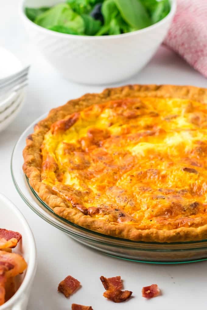 Quiche Lorraine - Easy and quick to prepare, this breakfast or brunch recipe will quickly become a weekly staple. It’s full of flavor that comes from just the right combination of bacon, cheese, half and half and eggs. Plus a little nutmeg and paprika to take it to the next level.