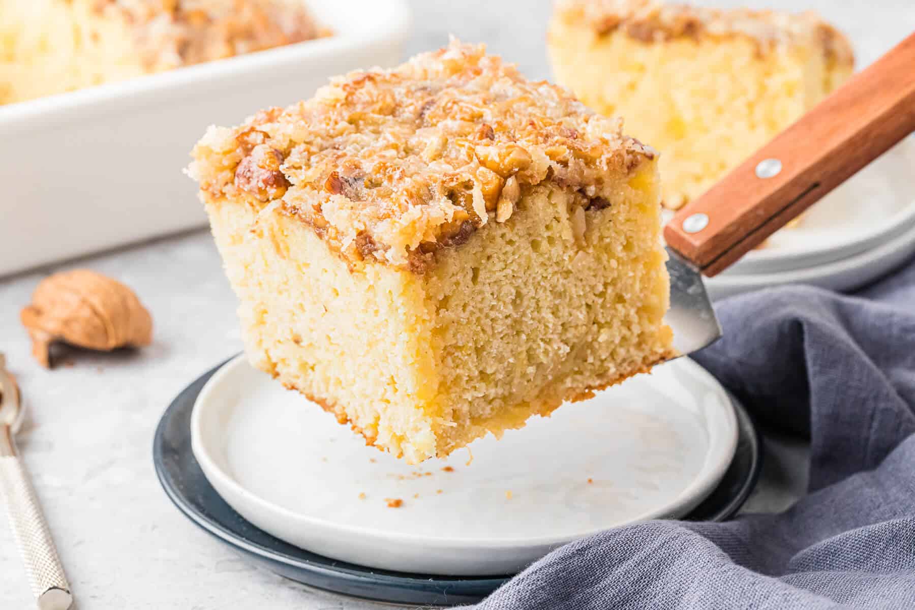 A piece of pineapple cake on a serving spatula.