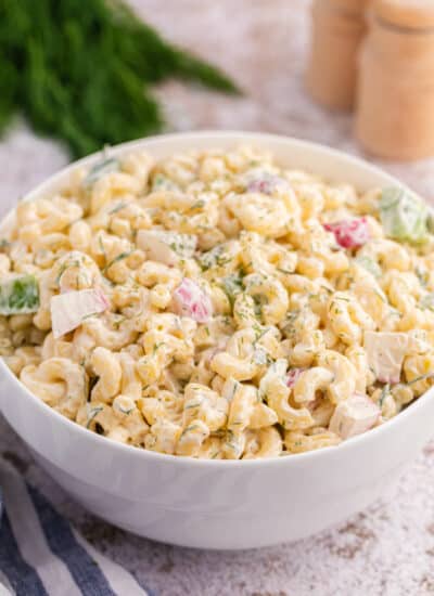 A white bowl with Macaroni Dill Salad.