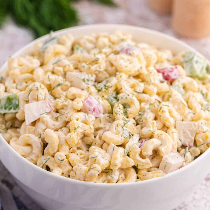A white bowl with Macaroni Dill Salad.