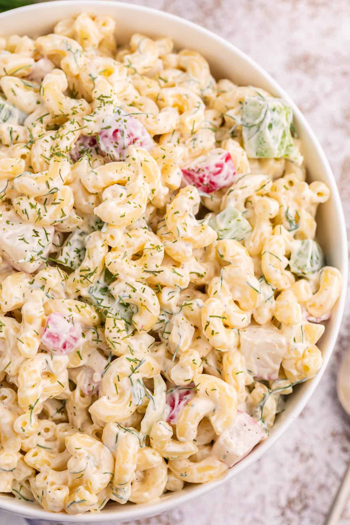 A white bowl of macaroni dill salad.