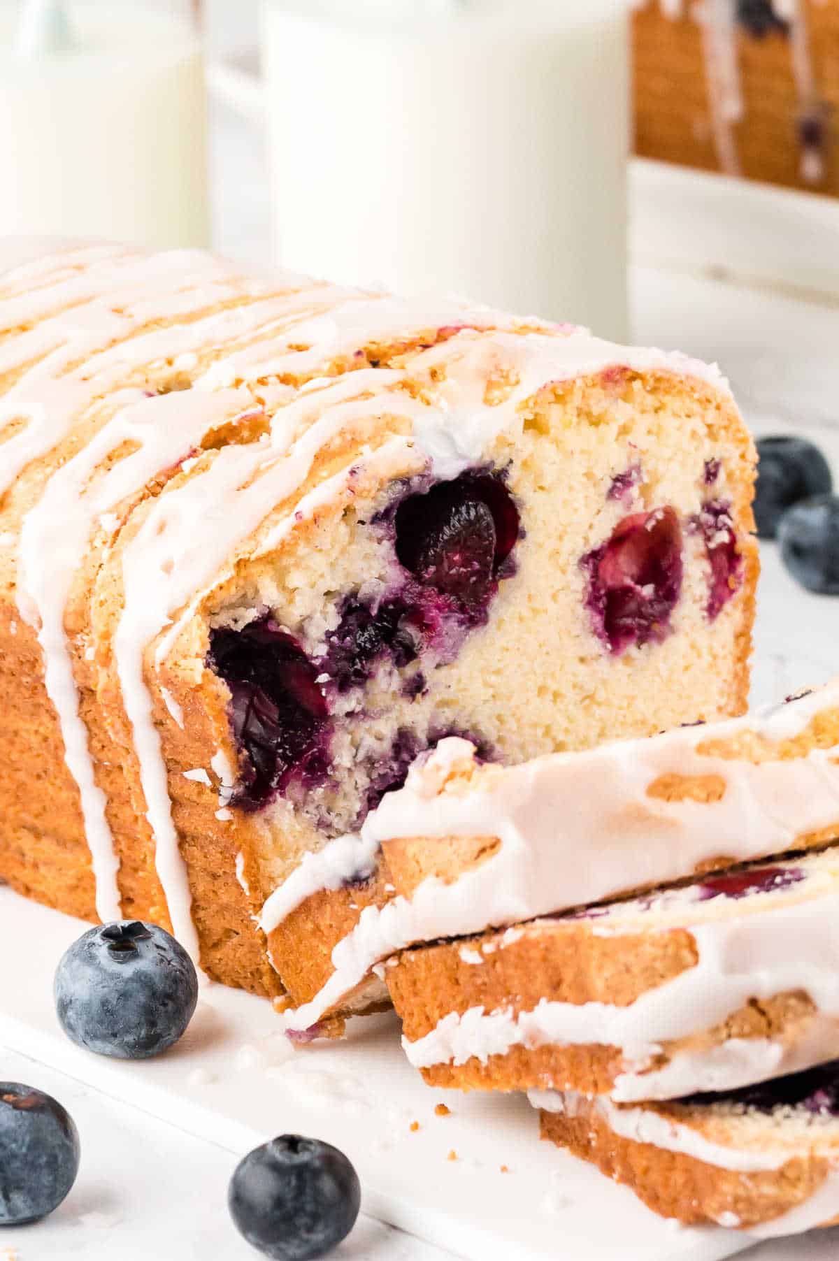 A loaf of blueberry bread with slices cut.