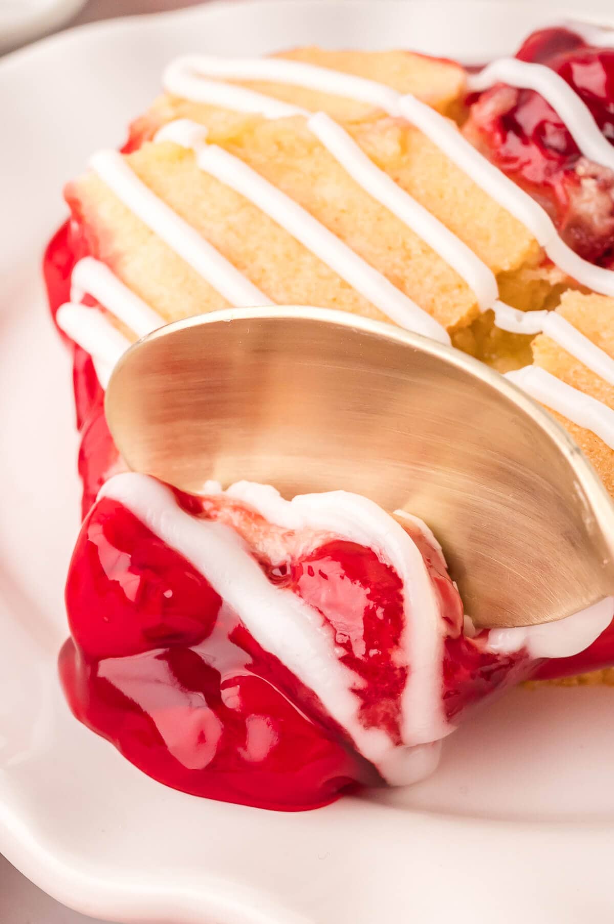 A spoon pushing through a piece of the recipe.