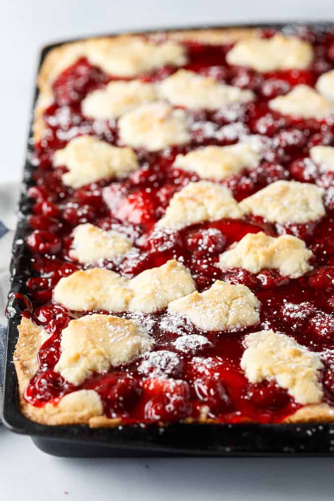 Quick Slice Cake - A simple fruit topped cake recipe made on a cookie sheet. The cake is sweet and dense and you can use any fruit pie filling you love!