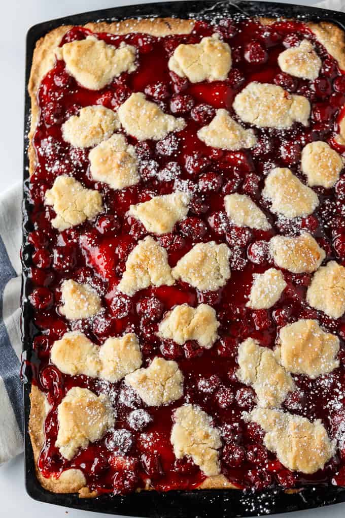 Quick Slice Cake - A simple fruit topped cake recipe made on a cookie sheet. The cake is sweet and dense and you can use any fruit pie filling you love!