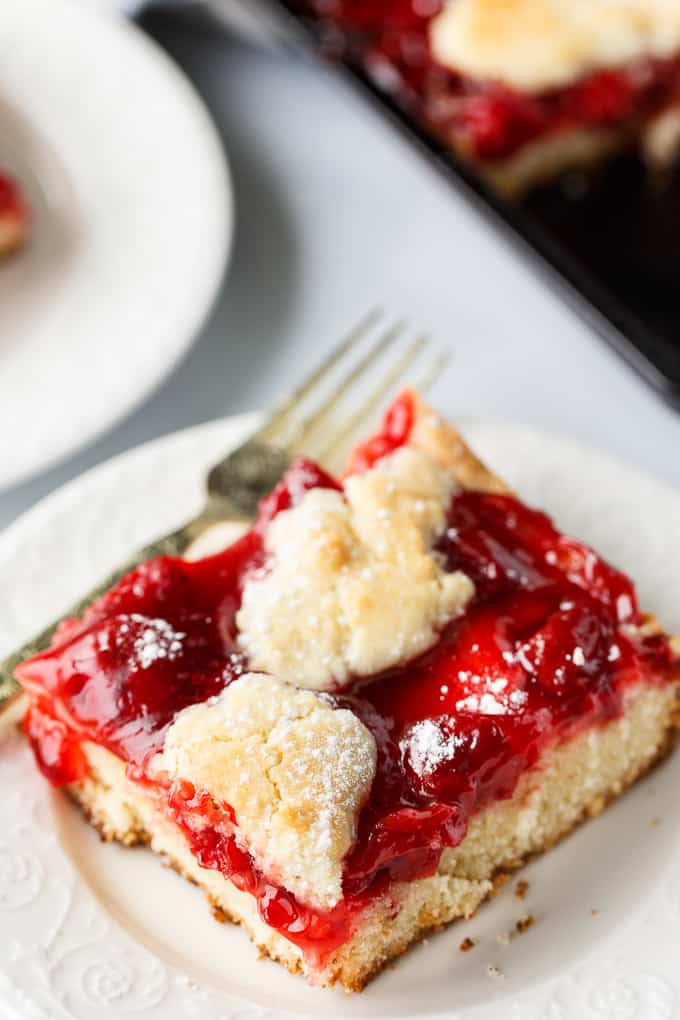 Quick Slice Cake - A simple fruit topped cake recipe made on a cookie sheet. The cake is sweet and dense and you can use any fruit pie filling you love!