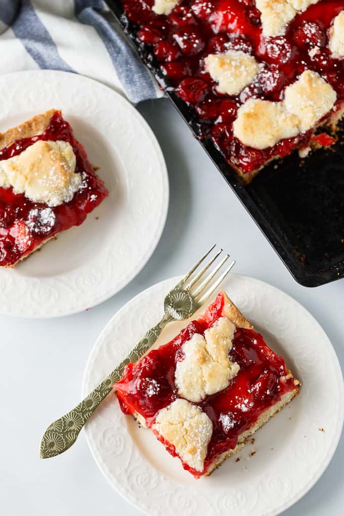 Quick Slice Cake - A simple fruit topped cake recipe made on a cookie sheet. The cake is sweet and dense and you can use any fruit pie filling you love!