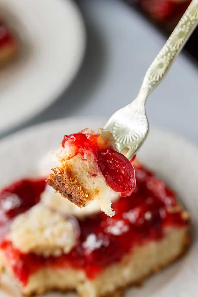 Quick Slice Cake - A simple fruit topped cake recipe made on a cookie sheet. The cake is sweet and dense and you can use any fruit pie filling you love!