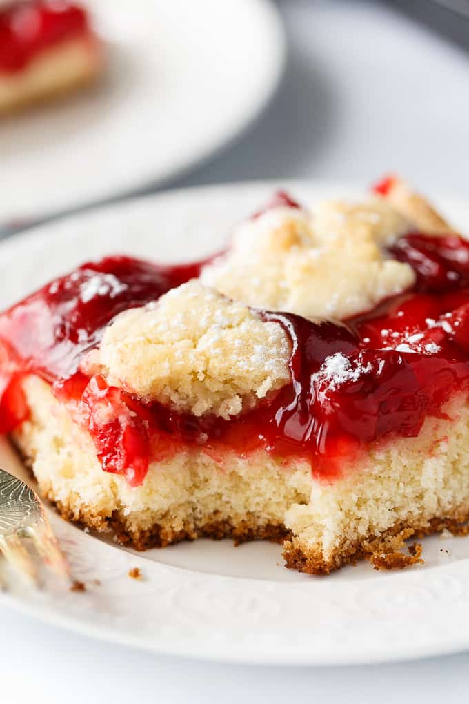 Quick Slice Cake - A simple fruit topped cake recipe made on a cookie sheet. The cake is sweet and dense and you can use any fruit pie filling you love!