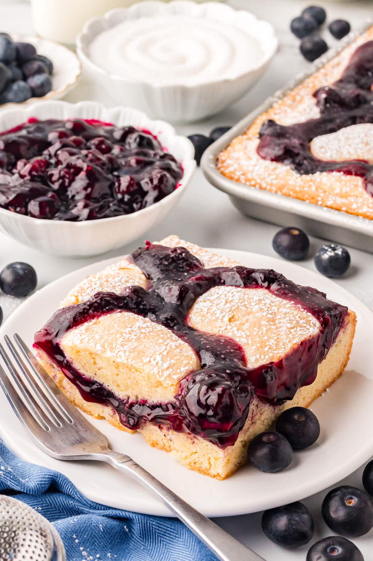 A piece of cake on a plate with a fork.