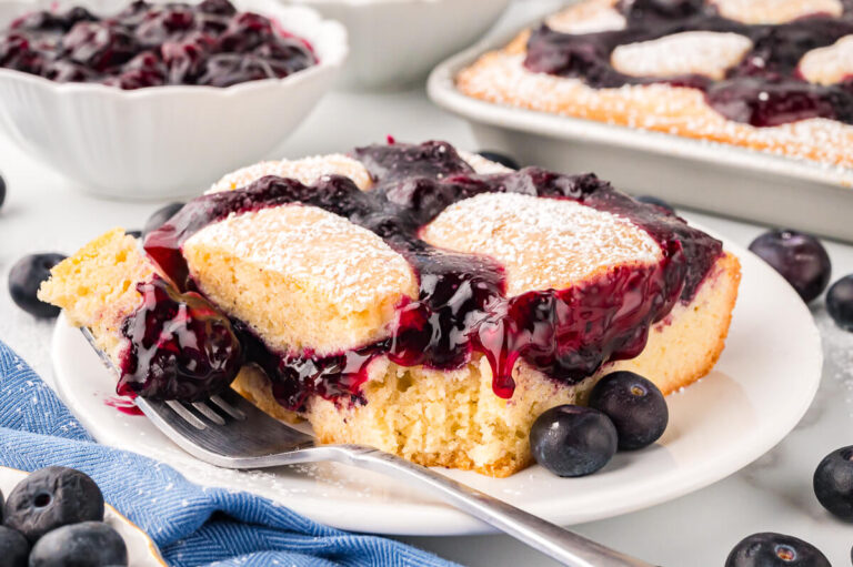 A slice of cake on a plate with fork.