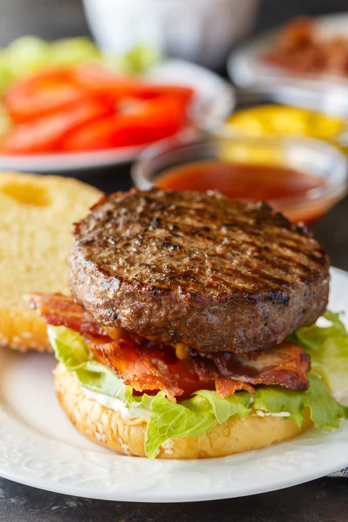 Easy Stuffed Burgers - The easiest stuffed burgers you'll ever make! Tender, juicy and flavorful beef patties are stuffed with cheddar cheese, mushrooms and onions. 